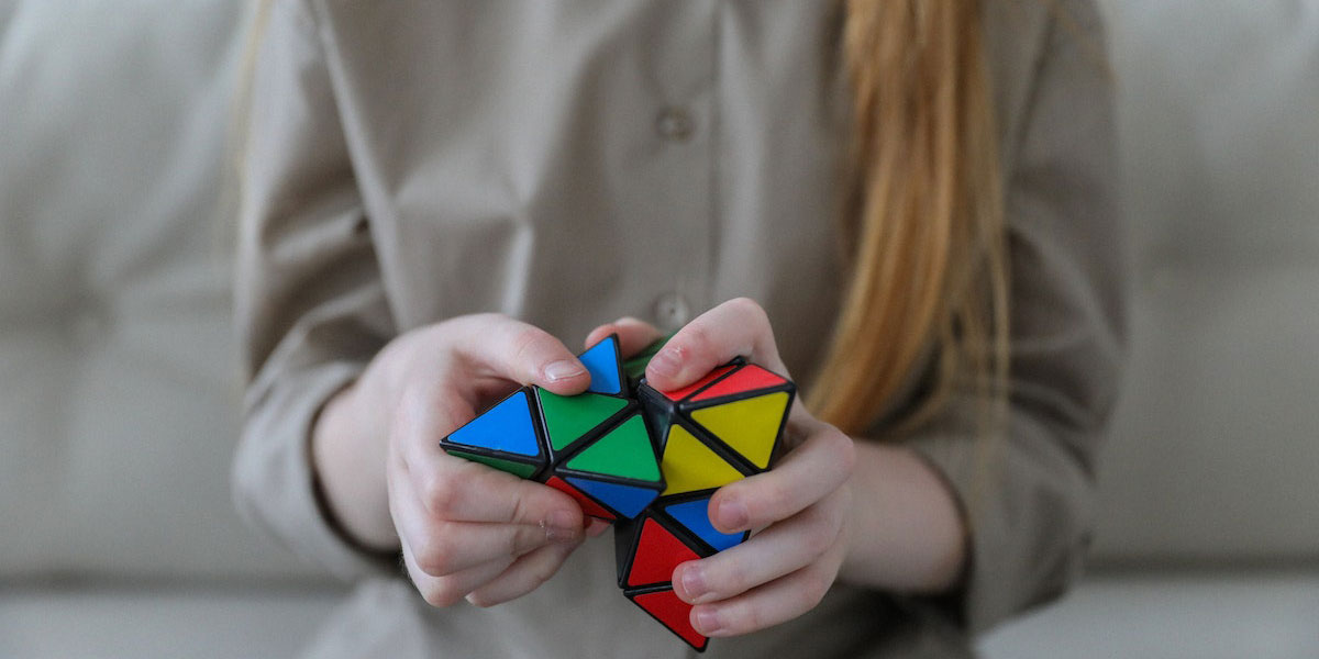 girl playing with rubix cube